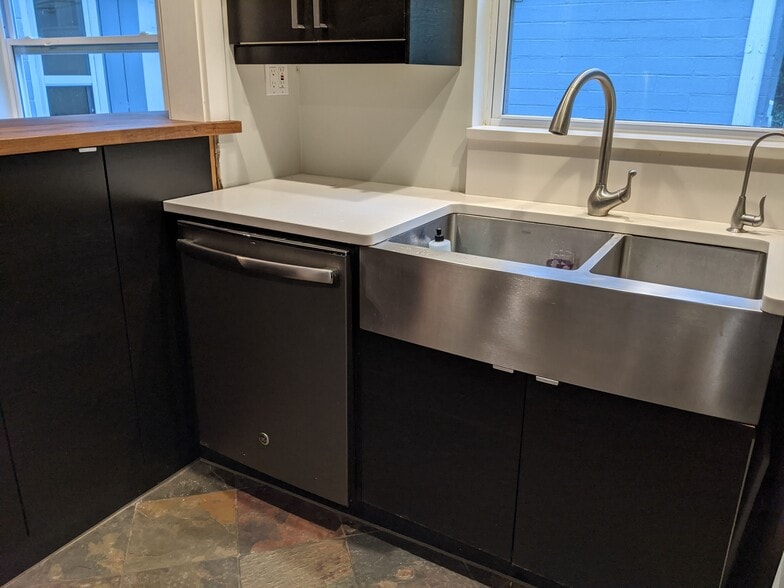 nice stainless dishwasher with deep stainless farmhouse sink - 513 NE 9th St