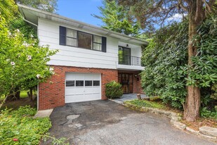 View of front of property with a garage and a balcony. - 45 High St