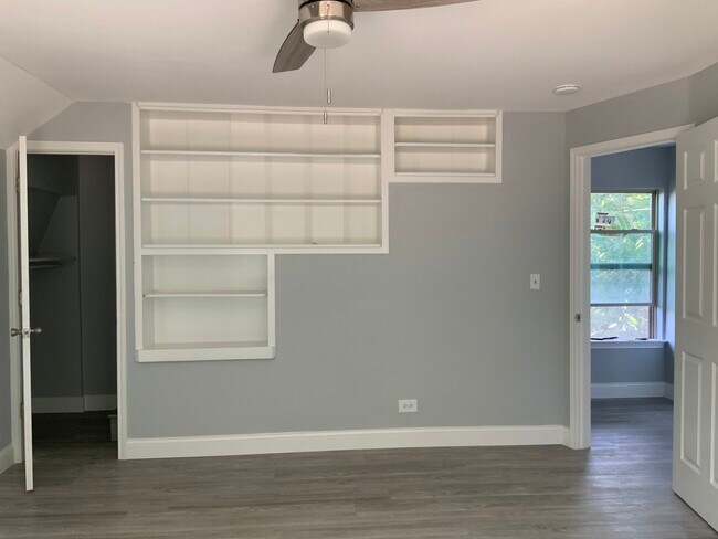 Bedroom 1- built in book shelves, door leading up to 3rd floor - 3816 Byers Ave