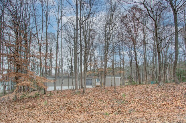 Building Photo - Nestled on a spacious, private wooded wate...