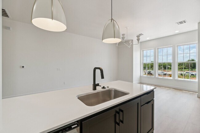 Building Photo - Bright. Clean. Calm. Your Elevated One-Bed...