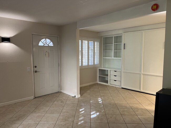 Living area with built-in shelving and Murphy bed - 8620 Via Mallorca