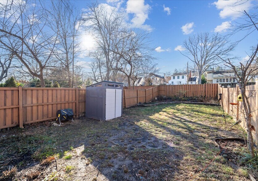 The backyard contains a fence, large flower-bed and shed for storage. - 706A W Glebe Rd