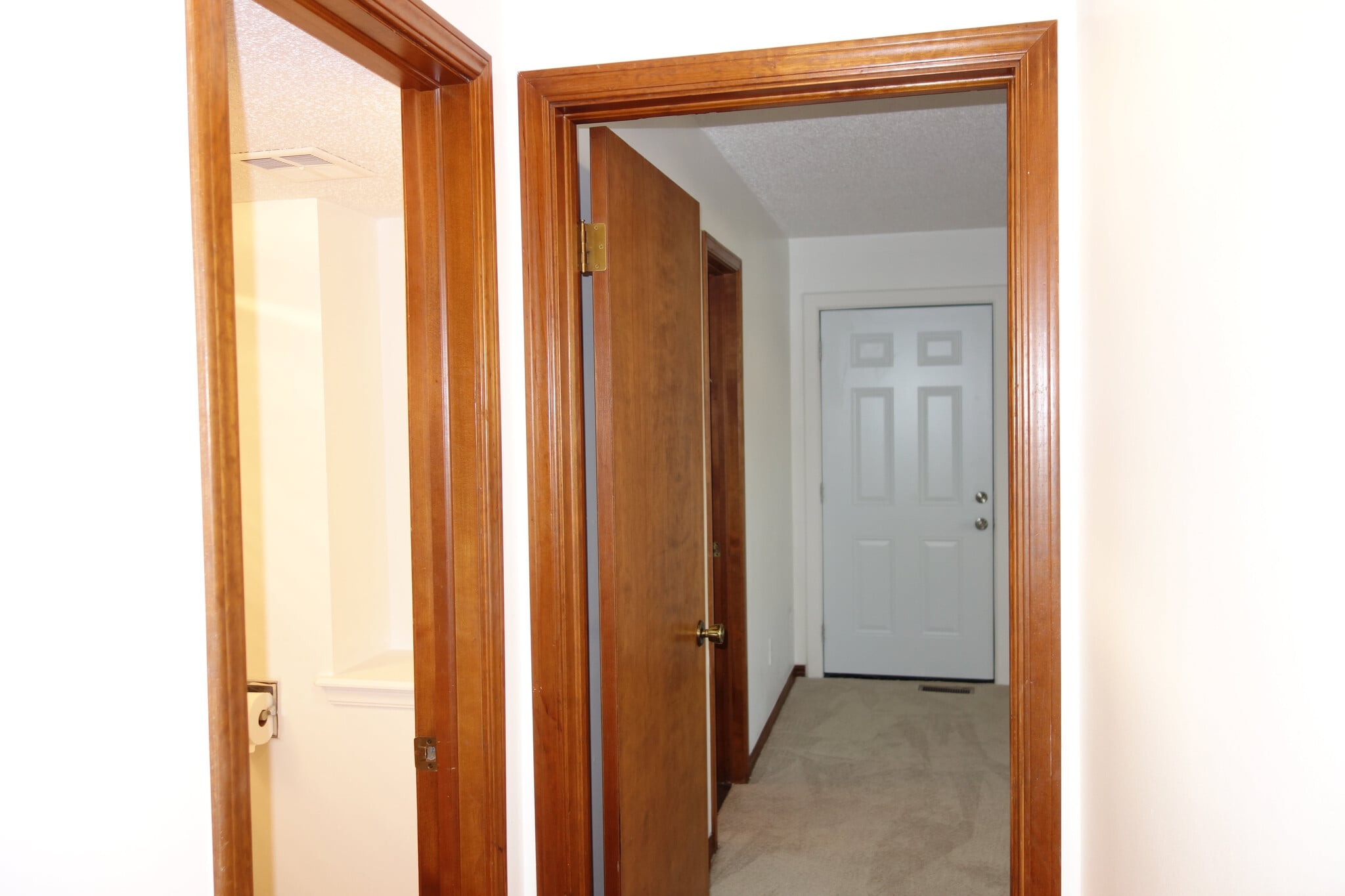 Hallway to half bath and master suite - 7116 S Indianapolis Ave