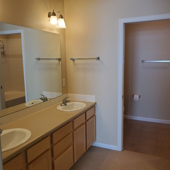 Primary bathroom with double vanity. Private tub-shower-toilet room attached. - 2214 Owens Ave