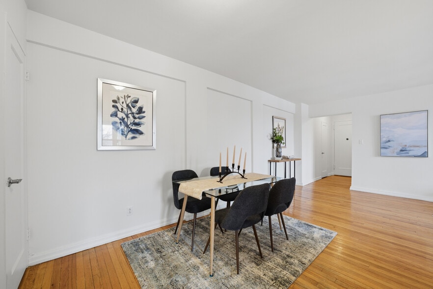 Dining area featuring hardwood floors with convenient access to the kitchen. - 555 Broadway