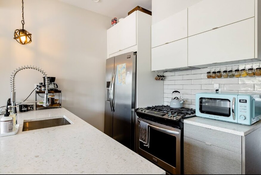 Gourmet kitchen with premium stainless steel appliances, full dishwasher, and full size gas range. - 504 Maple St