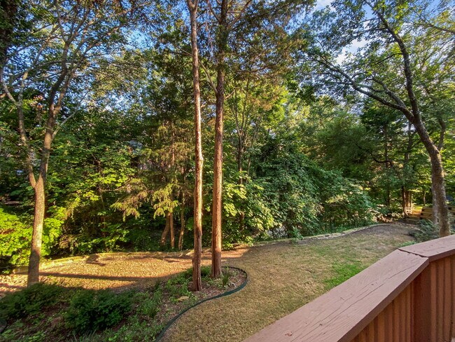 View from covered deck of wooded backyard with creek view. - 1314 Creekwood Dr