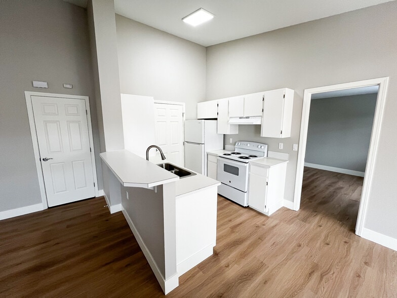 Large kitchen with peninsula and bar seating area. - 6521 W Lucky Ln