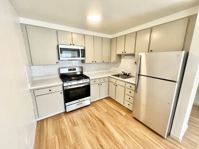 Experience culinary delight in this contemporary kitchen space. - Harmony Apartments