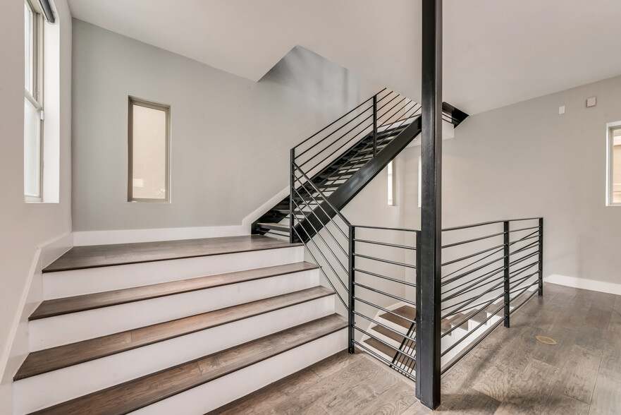 Wide open staircases connect the four floors. - 4434 Holland Ave