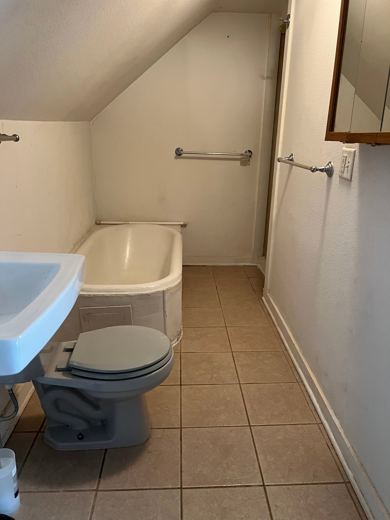 Bathroom with a bathtub on the left and a shower on the right corner - 2432 Prais St