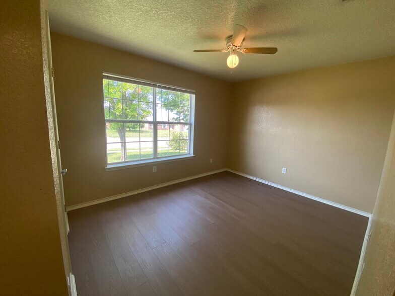 Front-facing bedroom featuring an oversized picture window and plenty of natural light. - 2806 Maria Dr