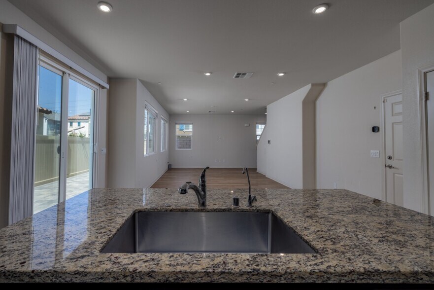 Modern open layout connecting the kitchen and living area - 26549 Brightstone Dr