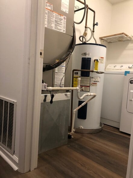 Water heater and brand new AC in laundry room. - 261 Simpson Ave