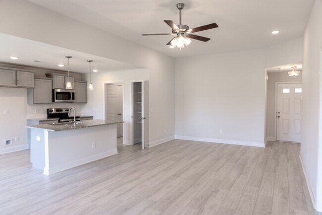 Building Photo - Modern Living Redefined with Stone Fireplace, Gray Cabinetry, Spa Inspired Primary Suite and Cove...