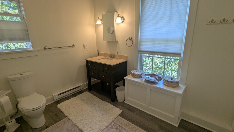 Large, spa-like bathrm in neutral tones w/ extra storage under window, linen closet, medicine cab. + - 156 Henry St