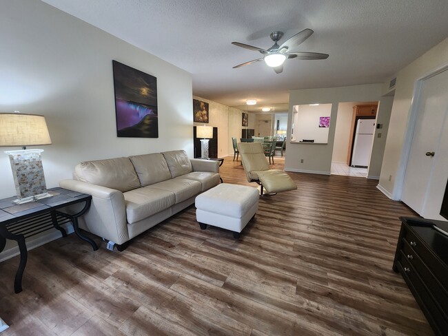 Bright, open-concept living area and dining area. - 1935 Silver Pine SW Way