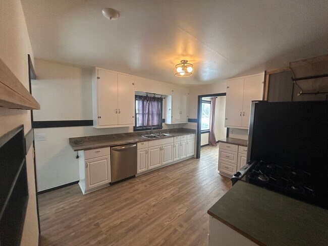 Building Photo - Bigfork Rodeo Farmhouse~ Fenced garden, greenhouse, garage, barn and shop!