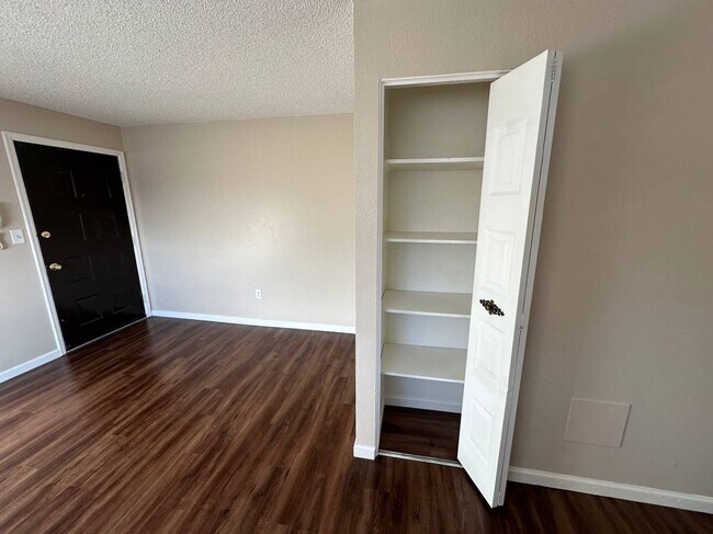 Step into style with this cozy entryway featuring modern wood floors and convenient storage. - Country Club