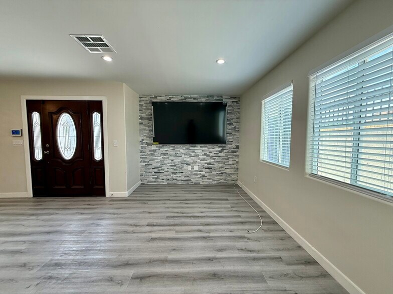 Living room with brand new TV - 1141 W 49th St