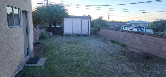 Building Photo - This is a spacious house featuring four bedrooms and two bathrooms, along with a two-car garage.