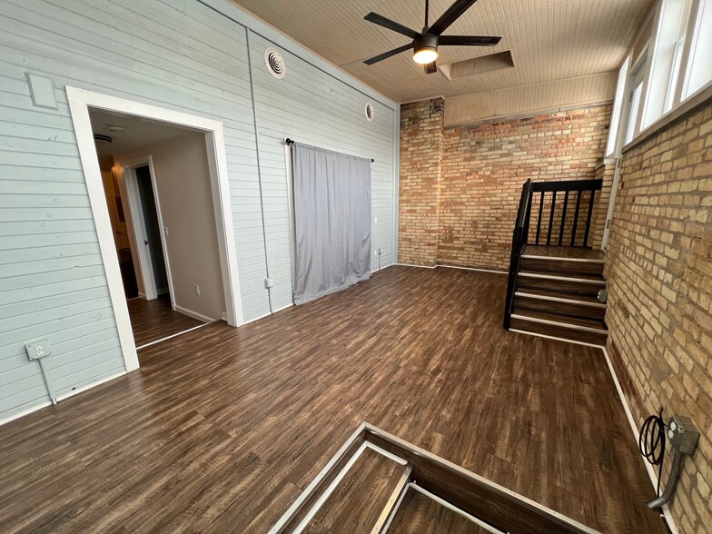 Living Room view from Bookcase with view of Stairs to Private Patio - 1216 Turner St