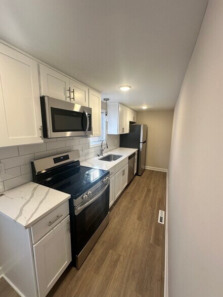 Kitchen w/ Quartz Countertops and Frigidaire Stainless Steel Appliances - 437 Franklin St