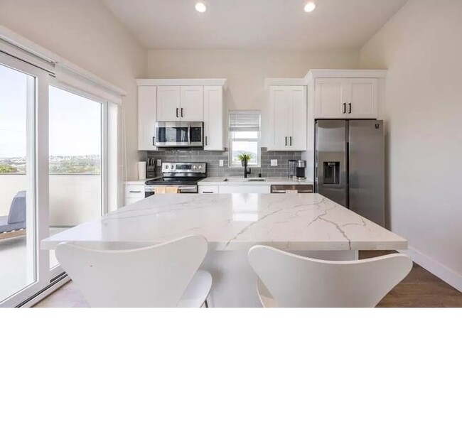 Coming up the stairs you find the beautiful new kitchen with quartz countertops. - 3355 Lloyd St