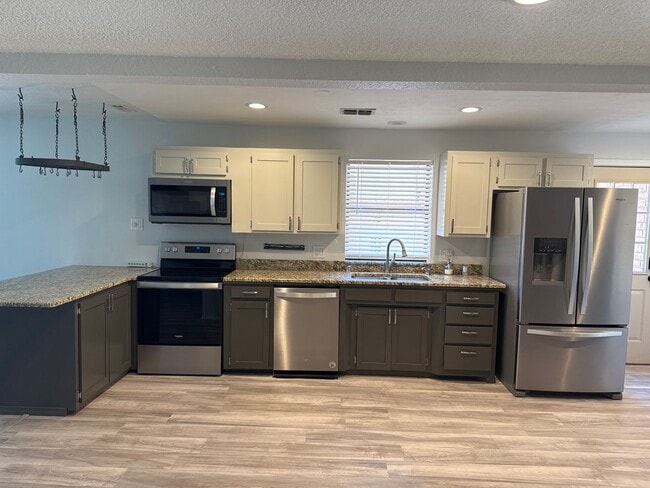 Building Photo - Two-story, four-bedroom, three-bathroom ho...