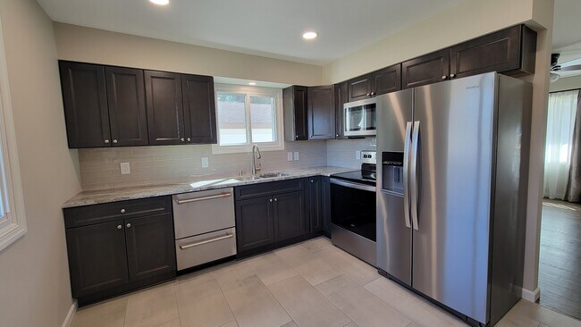 New Kitchen Cabinets and quartzite countertops. New stainless appliances. New Tile and backsplash. - 6305 49th Ave