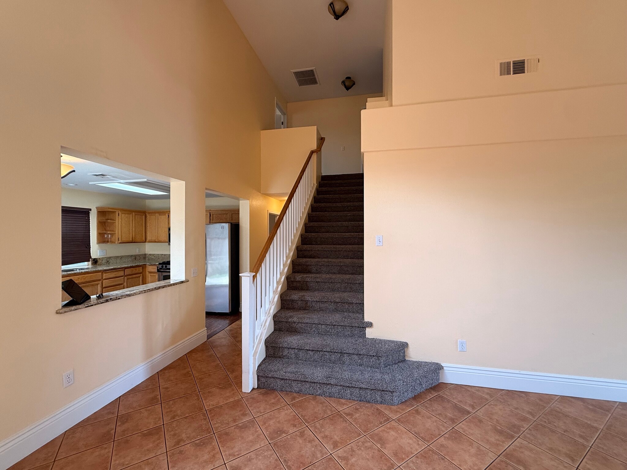 Living room looking at kitchen and stairs - 3326 Amberfield Cir