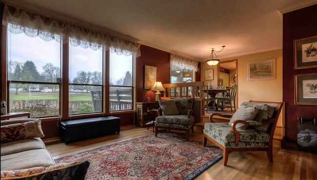 Building Photo - 4bd/3ba HUGE Home w/Hardwood Floors, Russian Fireplace, 2-Car Garage & Fenced Back Yard!