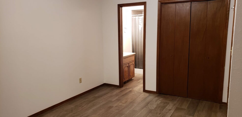 Master bedroom with view of bathroom. - 908 Acacia Cir