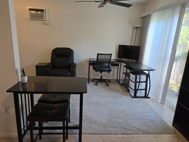 View from kitchen into living room. Workstation, reclyner, patio door. - 7649 Beckett St