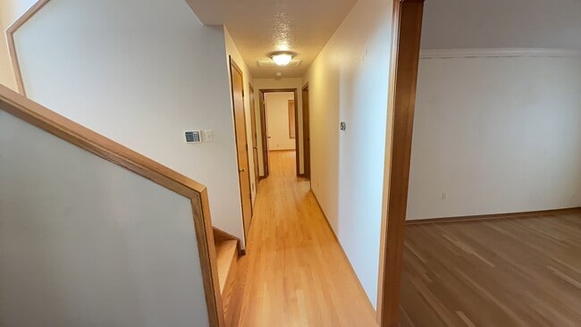 Building Photo - 4bd/3ba HUGE Home w/Hardwood Floors, Russian Fireplace, 2-Car Garage & Fenced Back Yard!