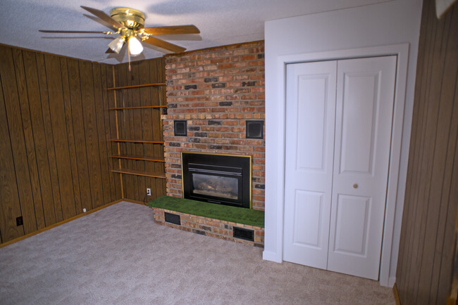 Main floor bedroom with gas fireplace and ceiling fan. - 1060 21st Ave SE