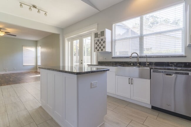 Building Photo - Beautiful 4/2 home Located on a tree lined street in the gate of country club community of the Hu...