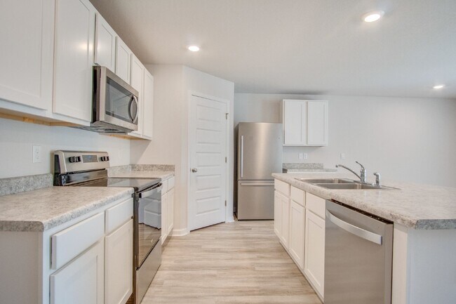 Building Photo - 4-Bed, 2-Bath Home in Woodlands Subdivision with Solar, Open-Concept Living, Modern Kitchen, Fenc...