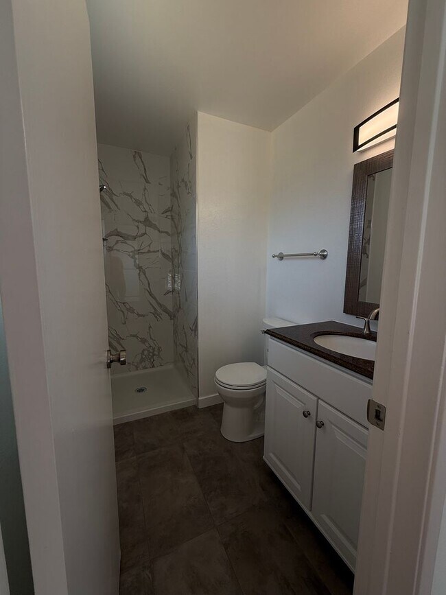 Building Photo - Recently updated home with new floors, paint & bathroom!