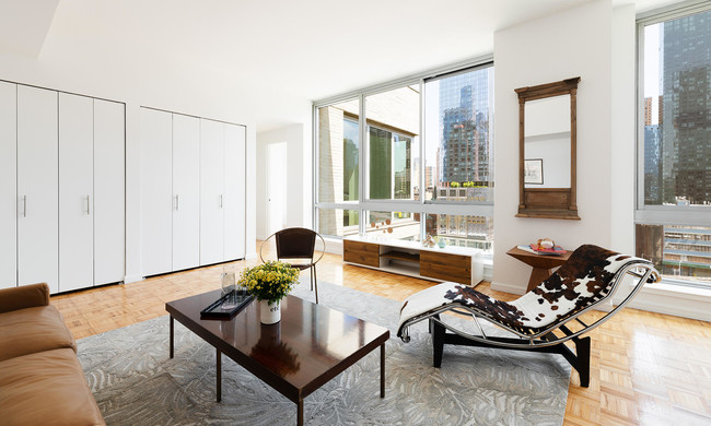 photo of 455 West 37th St Model Apartment 1017 view and living room staged with modern furniture - 455 W 37th St