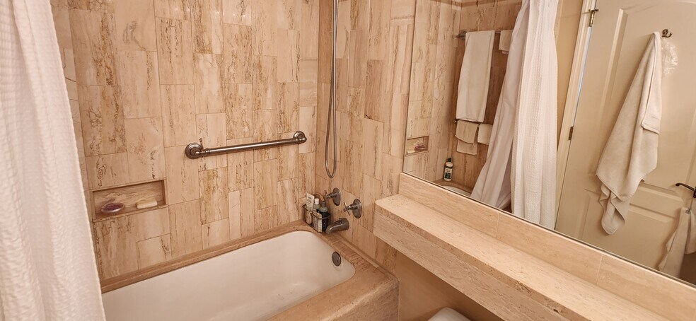 Marble clad bathroom with full tub - 700 Biltmore Way