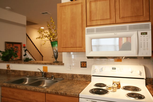 Electric stove and kitchen countertop - Senior Living at Matthew Henson Apartments