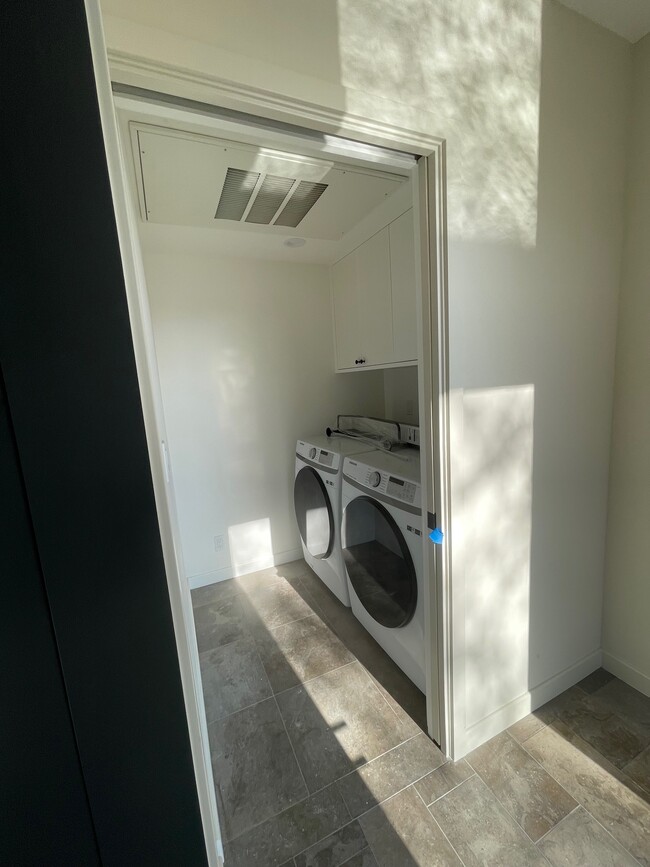 Full laundry room with washer, dryer, and storage. - 5285 College View Ave