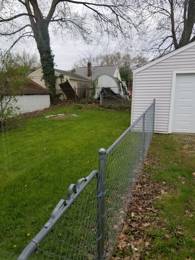 Fenced in backyard with fire pit. - 2455 Albrecht Ave