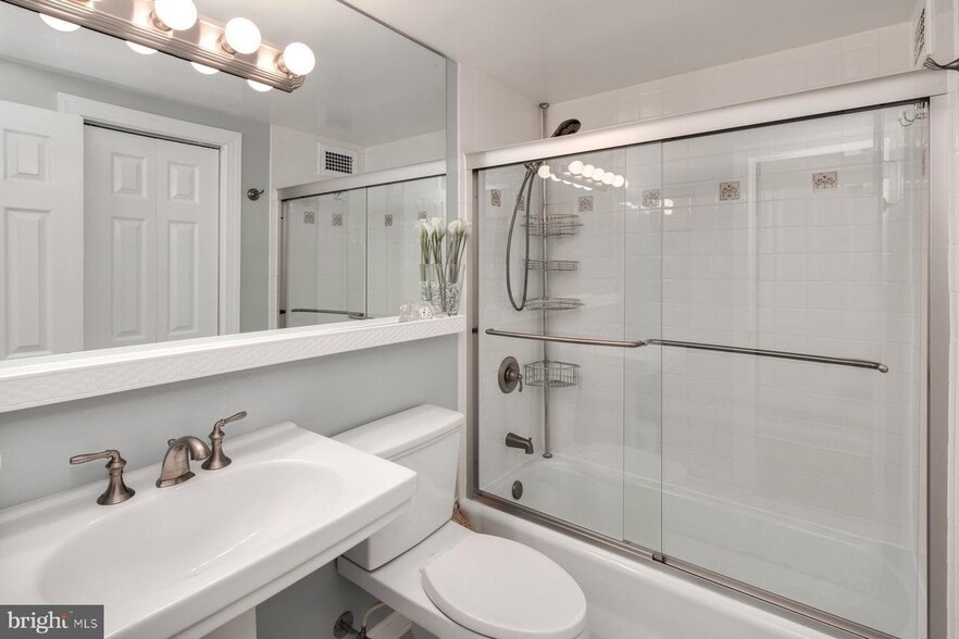 Bathroom with sliding-door shower and large cabinet storage - 2475 Virginia Ave NW