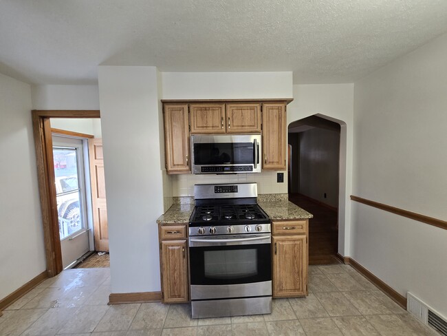 kitchen with microwave and gas stove - 97 Grimm Heights Ave