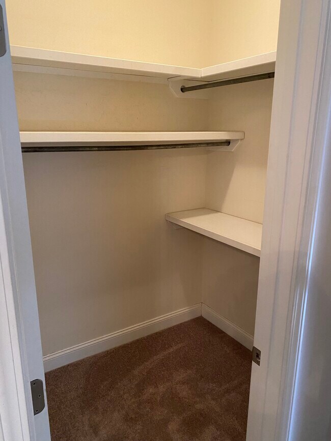 Primary suite walk-in closet. This bedroom has a bathroom with double vanities and garden tub. - 3406 Margrave Rd