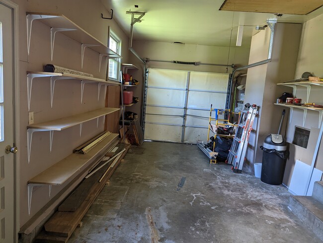 Garage with plenty of shelving. - 302 Mitchell Ave