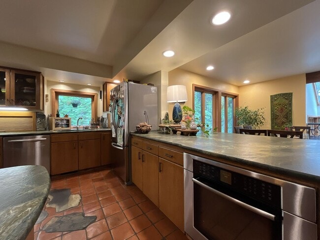 Building Photo - One-of-a-Kind Custom Home with Wall of Windows, Stone Fireplaces, Expansive Entertainment Space &...